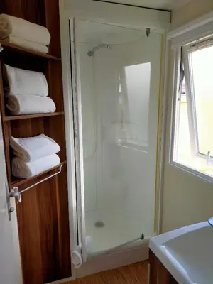 a shower with a glass door in a bathroom at FINCA VILLA ZAAR HOMES in Puerto Real