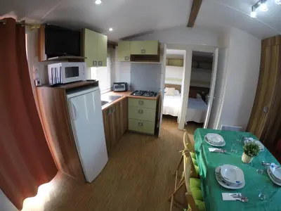 a small kitchen with a table in a room at FINCA VILLA ZAAR HOMES in Puerto Real