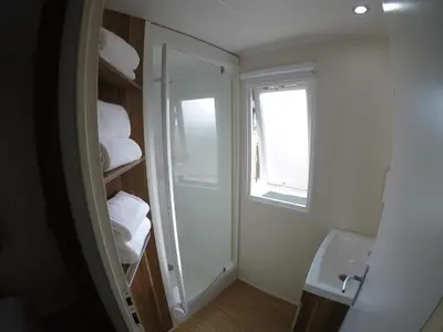 a bathroom with a toilet and a sink and a mirror at FINCA VILLA ZAAR HOMES in Puerto Real