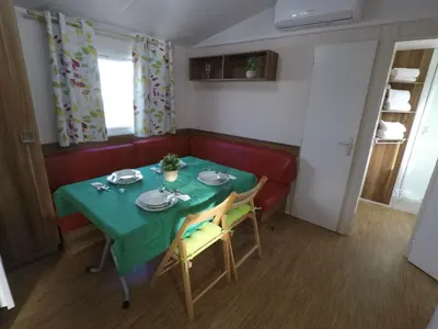 a dining room with a green table and chairs at FINCA VILLA ZAAR HOMES in Puerto Real