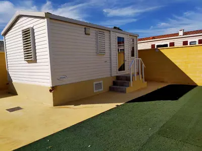 a small house with a ramp next to a building at FINCA VILLA ZAAR HOMES in Puerto Real
