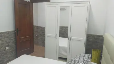 a bedroom with a white closet and a wooden door at FINCA VILLA ZAAR HOMES in Puerto Real