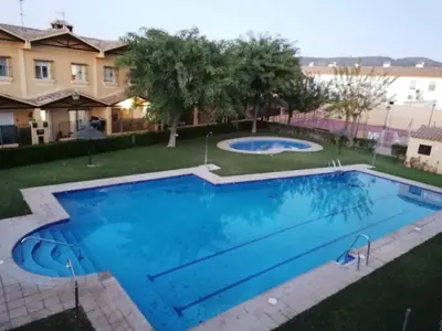 a large swimming pool with blue water at CASA LAGO in Arcos de la Frontera