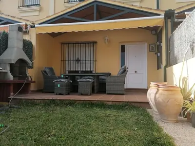a patio with a table and chairs and a grill at CASA LAGO in Arcos de la Frontera