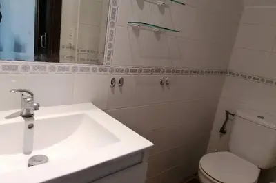 a bathroom with a sink and a toilet and a mirror at CASA LAGO in Arcos de la Frontera