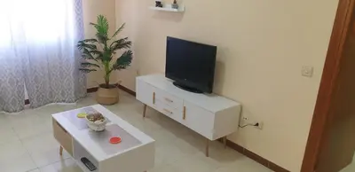 a living room with a tv on a white cabinet at Casa Mercedes in Rota