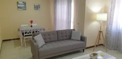 a living room with a couch and a table at Casa Mercedes in Rota