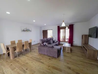 a living room with a couch and a table at Chalet Conil Ramirez in Conil de la Frontera