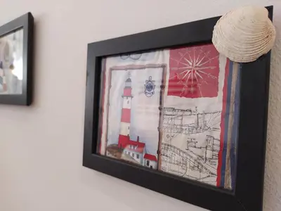 a framed picture of a lighthouse on a wall at AZAHAR-Playa Home by Cadiz4Rentals in Cádiz