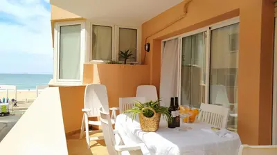 a white table and chairs on a balcony with the beach at AZAHAR-Playa Home by Cadiz4Rentals in Cádiz