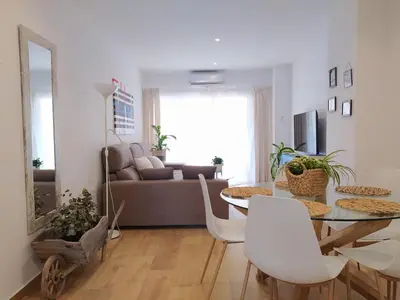 a living room with a table and a couch at AZAHAR-Playa Home by Cadiz4Rentals in Cádiz
