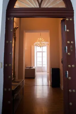 a doorway into a room with a chandelier at Casa Plaza de las Flores Cádiz Grupo AC Gestión in Cádiz