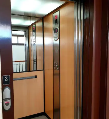 a row of wooden elevators in a building at Sherryflat Jarana- Parking in Jerez de la Frontera