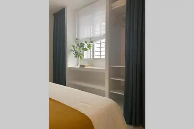 a bedroom with a bed and a window and a curtain at Palacio Caballeros. Parking/Wifi in Jerez de la Frontera