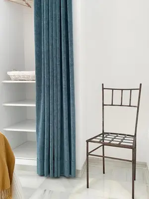 a green curtain and a chair in a room at Palacio Caballeros. Parking/Wifi in Jerez de la Frontera