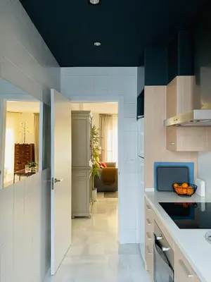 a kitchen with white counters and a blue ceiling at Palacio Caballeros. Parking/Wifi in Jerez de la Frontera