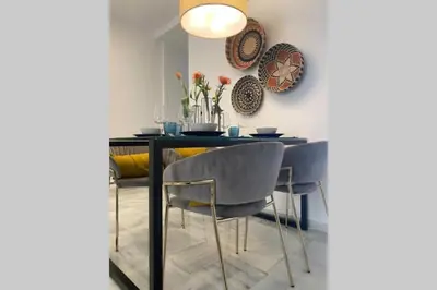 a dining room with a table and two chairs at Palacio Caballeros. Parking/Wifi in Jerez de la Frontera