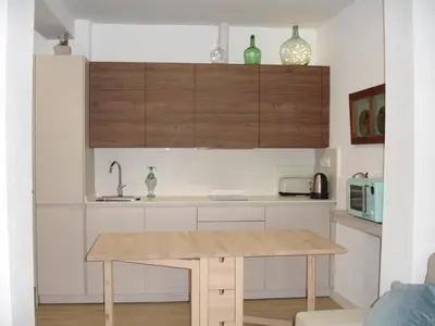 a kitchen with a wooden table in a room at Kiana Loft, La Casa del Parral in Jerez de la Frontera
