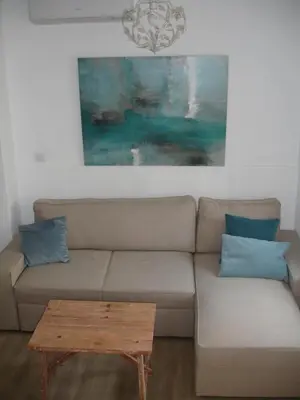 a living room with a couch and a table at Kiana Loft, La Casa del Parral in Jerez de la Frontera