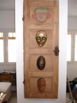a door with masks on it in a room at Kiana Loft, La Casa del Parral in Jerez de la Frontera