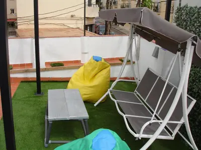 a swing and a chair and a yellow bag at Kiana Loft, La Casa del Parral in Jerez de la Frontera