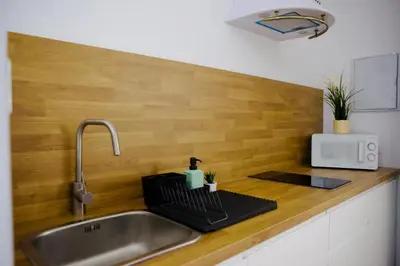 a kitchen sink with a faucet and a counter top at Loft CENTRO San Diego in Sanlúcar de Barrameda
