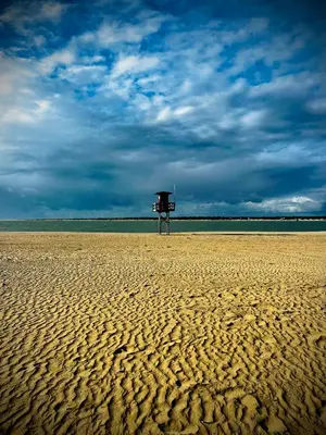 a stand on a sandy beach with a cloudy sky at Loft CENTRO San Diego in Sanlúcar de Barrameda