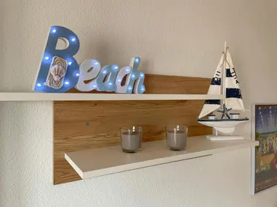 a shelf with two glasses and a sign and a boat at Azvalia - Valparaíso beach apartment - Piscina y parking gratis in El Puerto de Santa María