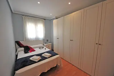 a small bedroom with a bed and a window at Avenida Paseo 3 Rooms 2 baños in Cádiz