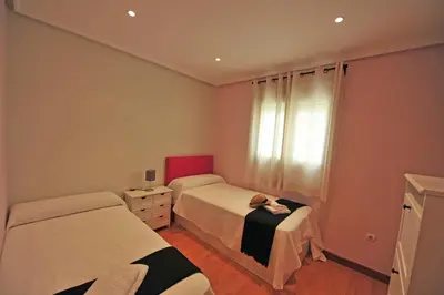 a bedroom with two beds and a window at Avenida Paseo 3 Rooms 2 baños in Cádiz