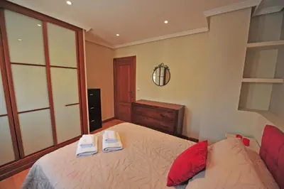a bedroom with a bed with two towels on it at Avenida Paseo 3 Rooms 2 baños in Cádiz
