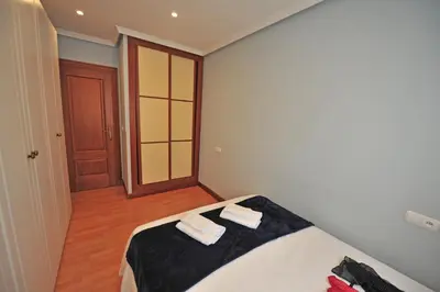 a bedroom with a bed with two towels on it at Avenida Paseo 3 Rooms 2 baños in Cádiz