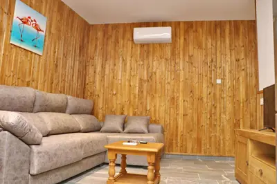 a living room with a couch and a table at Chalet Brenes Sol in Conil de la Frontera