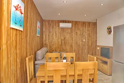 a dining room with a table and a couch at Chalet Brenes Sol in Conil de la Frontera