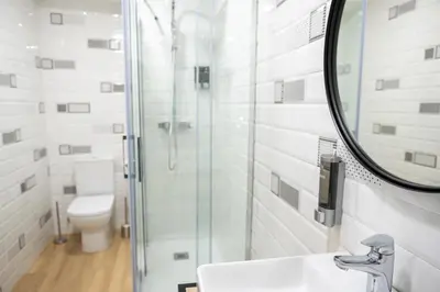 a bathroom with a toilet and a sink and a mirror at El mirador de Ancha in Cádiz
