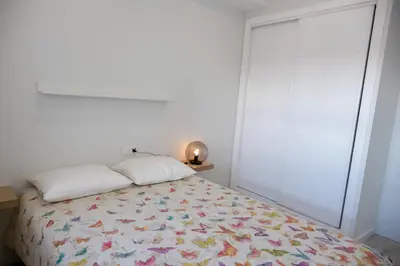 a bedroom with a bed and a large window at El mirador de Ancha in Cádiz