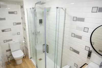 a bathroom with a toilet and a glass shower at El mirador de Ancha in Cádiz