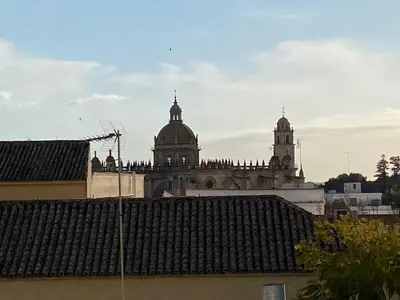 an old building with two domes on top of it at Cartujano City Center Apartment in Jerez de la Frontera
