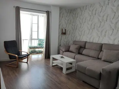 a living room with a couch and a chair at Apartamento La Paraíta in Chiclana de la Frontera