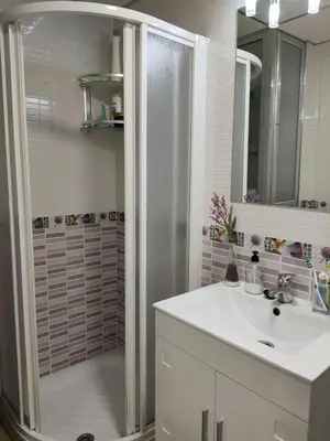 a bathroom with a shower and a white sink at Apartamento La Paraíta in Chiclana de la Frontera