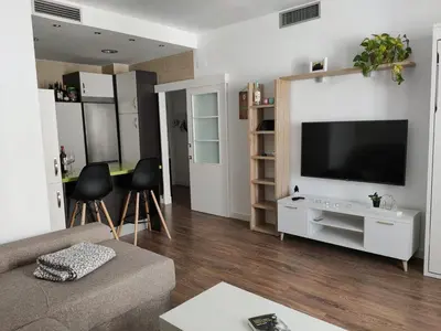 a living room with a couch and a flat screen tv at Apartamento La Paraíta in Chiclana de la Frontera