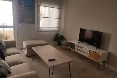 a living room with a couch and a flat screen tv at La Isla Centro II in San Fernando