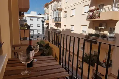 a bottle of wine and a glass on a balcony at La Isla Centro II in San Fernando