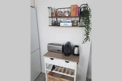 a kitchen with a small table and a shelf at La Isla Centro II in San Fernando