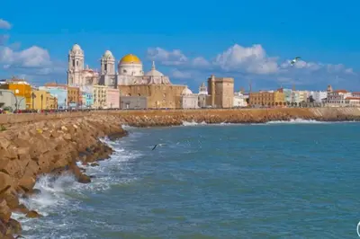 a group of buildings on the beach near the water at La Isla Centro II in San Fernando