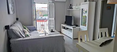 a living room with a couch and a television at Piso 100 metros del Centro del Pueblo 6 kilómetros de la PLAYA La BARROSa in Chiclana de la Frontera