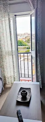 a remote control sitting on a table in front of a window at Piso 100 metros del Centro del Pueblo 6 kilómetros de la PLAYA La BARROSa in Chiclana de la Frontera