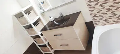 a bathroom with a sink and white cabinets at Piso 100 metros del Centro del Pueblo 6 kilómetros de la PLAYA La BARROSa in Chiclana de la Frontera