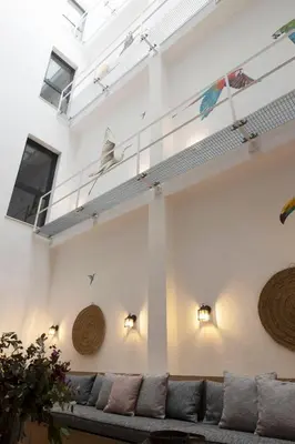 a living room with a couch and a table and chairs at Goodnight Cádiz Apartments in Cádiz
