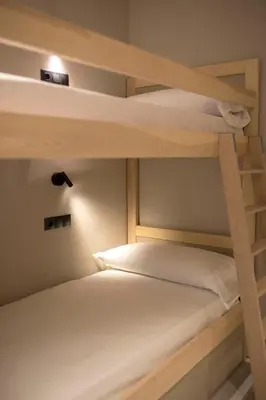 a bedroom with a white bed with two pillows at Goodnight Cádiz Apartments in Cádiz